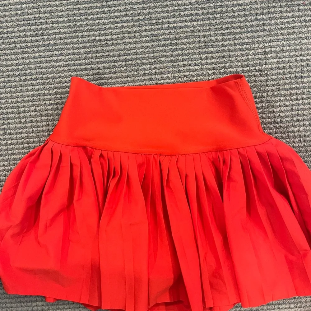 Red pleated also tennis skirt